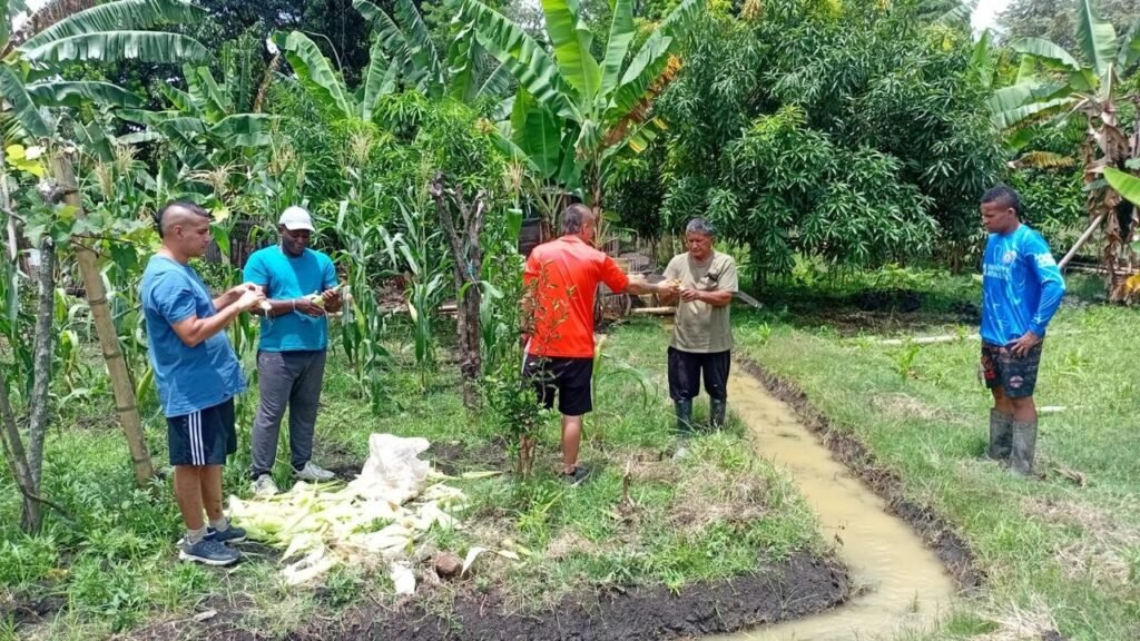 Deltagare arbetar tillsammans utomhus med trädgårdsredskap hos Fundación Lagom i Colombia